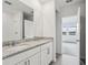 Double vanity bathroom with granite countertop and adjacent bedroom view at 2522 Linda Knoll Ln, Bartow, FL 33830