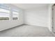 Bright bedroom with neutral carpeting and two windows at 2522 Linda Knoll Ln, Bartow, FL 33830