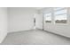 Well-lit bedroom featuring neutral carpeting and an exterior door at 2522 Linda Knoll Ln, Bartow, FL 33830