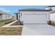 New construction home exterior featuring a two-car garage and walkway at 2522 Linda Knoll Ln, Bartow, FL 33830