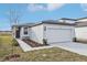 One story home with attached garage, landscaping, and dark gray door at 2522 Linda Knoll Ln, Bartow, FL 33830