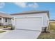 Attached garage with white door and stone accents at 2522 Linda Knoll Ln, Bartow, FL 33830