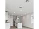 Open concept kitchen with island, stainless steel appliances, and white cabinets at 2522 Linda Knoll Ln, Bartow, FL 33830