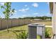 A green backyard featuring a view of construction, shrubbery, and an AC unit at 2526 Linda Knoll Ln, Bartow, FL 33830