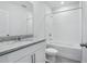 Bathroom includes a granite vanity, tile flooring, and shower-tub combination with white tiles at 2526 Linda Knoll Ln, Bartow, FL 33830