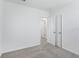 The carpeted bedroom features neutral walls and includes a double door closet with access to the ensuite bathroom at 2526 Linda Knoll Ln, Bartow, FL 33830