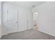 Comfortable carpeted bedroom features neutral walls with a door opening into the adjacent bathroom at 2526 Linda Knoll Ln, Bartow, FL 33830