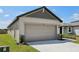 Two car garage with ample driveway space and stone accents at 2526 Linda Knoll Ln, Bartow, FL 33830