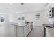 Modern kitchen island with granite countertops and a sink, open to the living area and bright windows at 2526 Linda Knoll Ln, Bartow, FL 33830