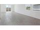 Bright open-plan living area with tiled floors, large windows, and sliding door access to the backyard at 2526 Linda Knoll Ln, Bartow, FL 33830