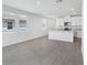 Bright, open living space with tile flooring and large windows, flowing into a modern kitchen at 2526 Linda Knoll Ln, Bartow, FL 33830