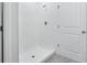 Shower features white tiling, a shower head, and new flooring at 2526 Linda Knoll Ln, Bartow, FL 33830