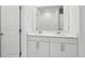 Double vanity bathroom with white cabinets and a large mirror at 2530 Linda Knoll Ln, Bartow, FL 33830