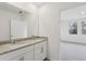 Bathroom boasts granite countertops, double sinks, and a view of a bedroom at 2534 Linda Knoll Ln, Bartow, FL 33830