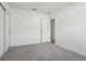 Bright bedroom with grey carpet and an open door at 2534 Linda Knoll Ln, Bartow, FL 33830