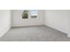 Bright bedroom with grey carpet and two windows at 2534 Linda Knoll Ln, Bartow, FL 33830
