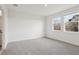 Spacious bedroom with grey carpet and two windows at 2534 Linda Knoll Ln, Bartow, FL 33830