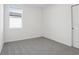 Simple bedroom with grey carpet and large window at 2534 Linda Knoll Ln, Bartow, FL 33830