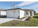 New single-story house with attached garage, teal door, and walkway at 2534 Linda Knoll Ln, Bartow, FL 33830