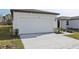White double-car garage with stone accents at 2534 Linda Knoll Ln, Bartow, FL 33830