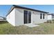 Well-maintained house exterior with a sliding glass door and small lawn at 2534 Linda Knoll Ln, Bartow, FL 33830