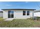 Rear view of house showing sliding glass door, windows, and lawn at 2534 Linda Knoll Ln, Bartow, FL 33830