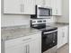 Modern kitchen with stainless steel appliances and granite countertops at 2534 Linda Knoll Ln, Bartow, FL 33830