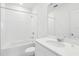 Clean bathroom with white tile, bathtub, and vanity with quartz countertop at 2538 Linda Knoll Ln, Bartow, FL 33830