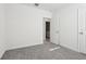 Well-lit bedroom with grey carpet, door to bathroom, and neutral walls at 2538 Linda Knoll Ln, Bartow, FL 33830