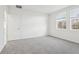 Bright bedroom with gray carpet and two large windows at 2538 Linda Knoll Ln, Bartow, FL 33830