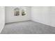 Bright bedroom with grey carpet and two large windows at 2538 Linda Knoll Ln, Bartow, FL 33830