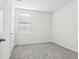Simple bedroom with grey carpet, window with blinds and neutral walls at 2538 Linda Knoll Ln, Bartow, FL 33830