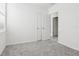 Spacious bedroom featuring grey carpet, neutral walls, and a door to hallway at 2538 Linda Knoll Ln, Bartow, FL 33830