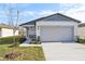 Newly constructed home with gray garage door and light-colored siding at 2538 Linda Knoll Ln, Bartow, FL 33830