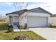 New house with gray garage door and light-colored exterior at 2538 Linda Knoll Ln, Bartow, FL 33830