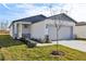 New construction home with gray garage door and a light-colored exterior at 2538 Linda Knoll Ln, Bartow, FL 33830