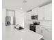 Eat-in kitchen with white cabinets, stainless steel appliances, and quartz countertops at 2538 Linda Knoll Ln, Bartow, FL 33830