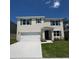 Charming two-story home featuring a manicured lawn, two car garage, and lovely dark green shutters at 3541 Sandalwood Isle Way, Ocoee, FL 34761