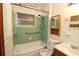 Classic bathroom featuring a shower/tub combination with green tile and modern fixtures at 1040 Santa Anita St, Orlando, FL 32808