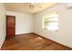 This bedroom has natural light coming from its window and a ceiling fan at 1040 Santa Anita St, Orlando, FL 32808