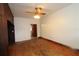 Empty bedroom shows hardwood floors, ceiling fan and closet at 1040 Santa Anita St, Orlando, FL 32808