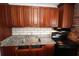 An updated kitchen with granite counters, wood cabinets and stainless steel appliances at 1040 Santa Anita St, Orlando, FL 32808