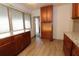 Well-lit kitchen showcases granite countertops and wood cabinets, offering ample storage at 1040 Santa Anita St, Orlando, FL 32808