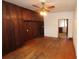 Spacious living room featuring hardwood floors, ceiling fan, and built-in wood cabinets at 1040 Santa Anita St, Orlando, FL 32808