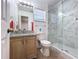 Renovated bathroom with granite counters and marble tiled shower at 1469 Swan Pl, Kissimmee, FL 34759