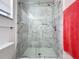 Bathroom with a large, frameless shower and marble tile at 1469 Swan Pl, Kissimmee, FL 34759