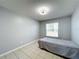 Cozy bedroom with tiled floor and a bright window view at 1469 Swan Pl, Kissimmee, FL 34759