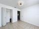 Bright, minimalist bedroom with tiled floors and closet at 1469 Swan Pl, Kissimmee, FL 34759