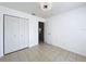 Simple bedroom with tile floors and double door closet at 1469 Swan Pl, Kissimmee, FL 34759