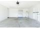Spacious garage with concrete floor and overhead lighting, offering ample storage with cabinet and water heater at 1469 Swan Pl, Kissimmee, FL 34759